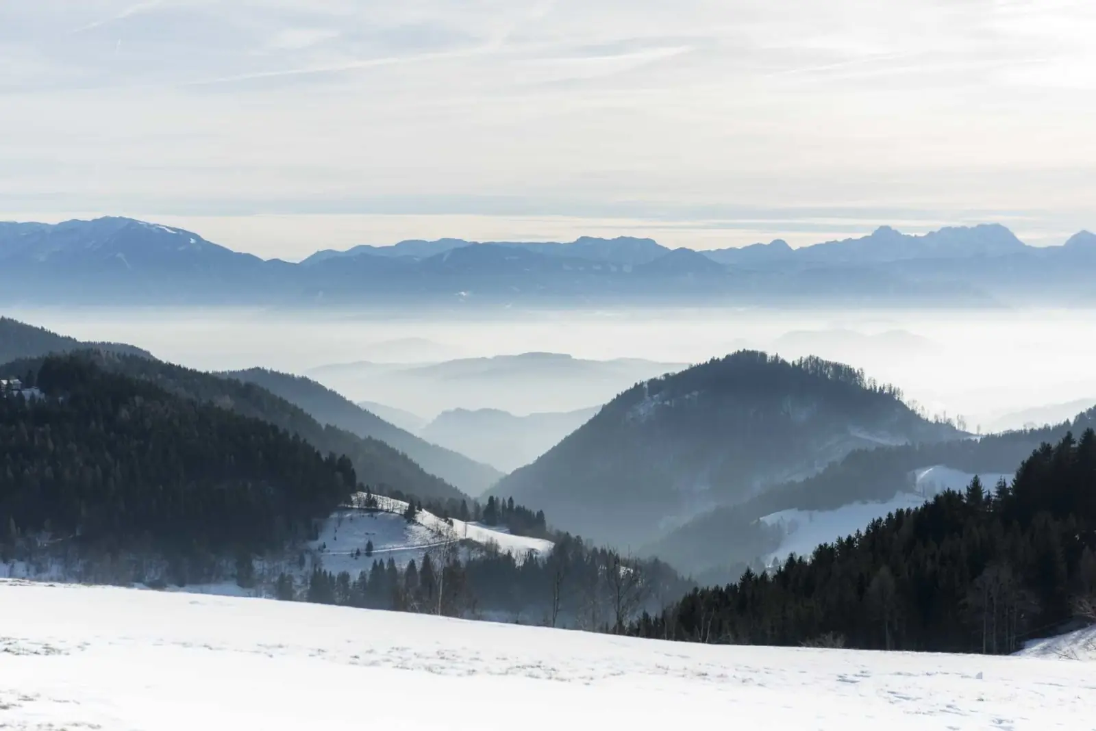 Distant view across misty valleys to the mountains