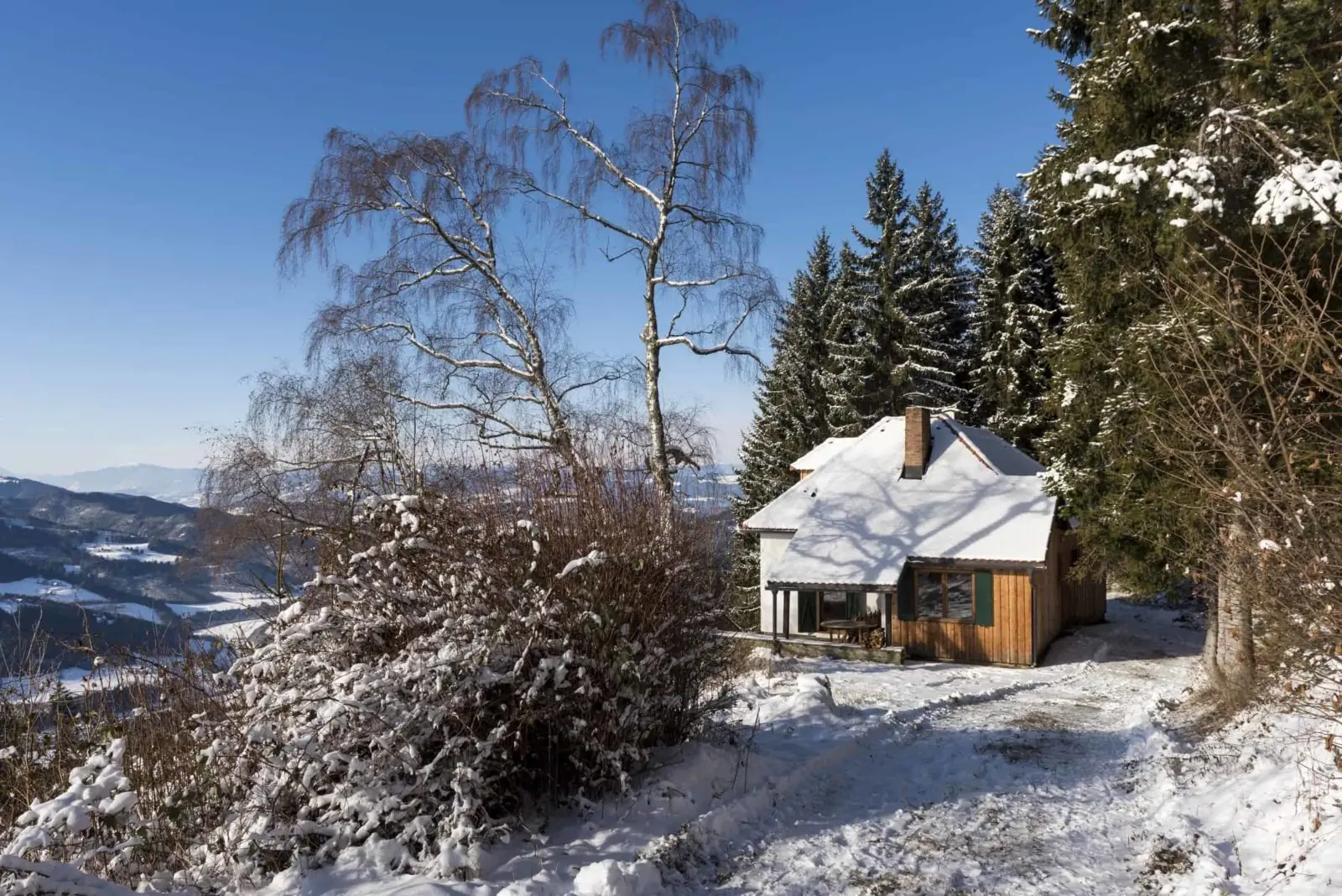 The Almhaus in the snow with a view into the valley