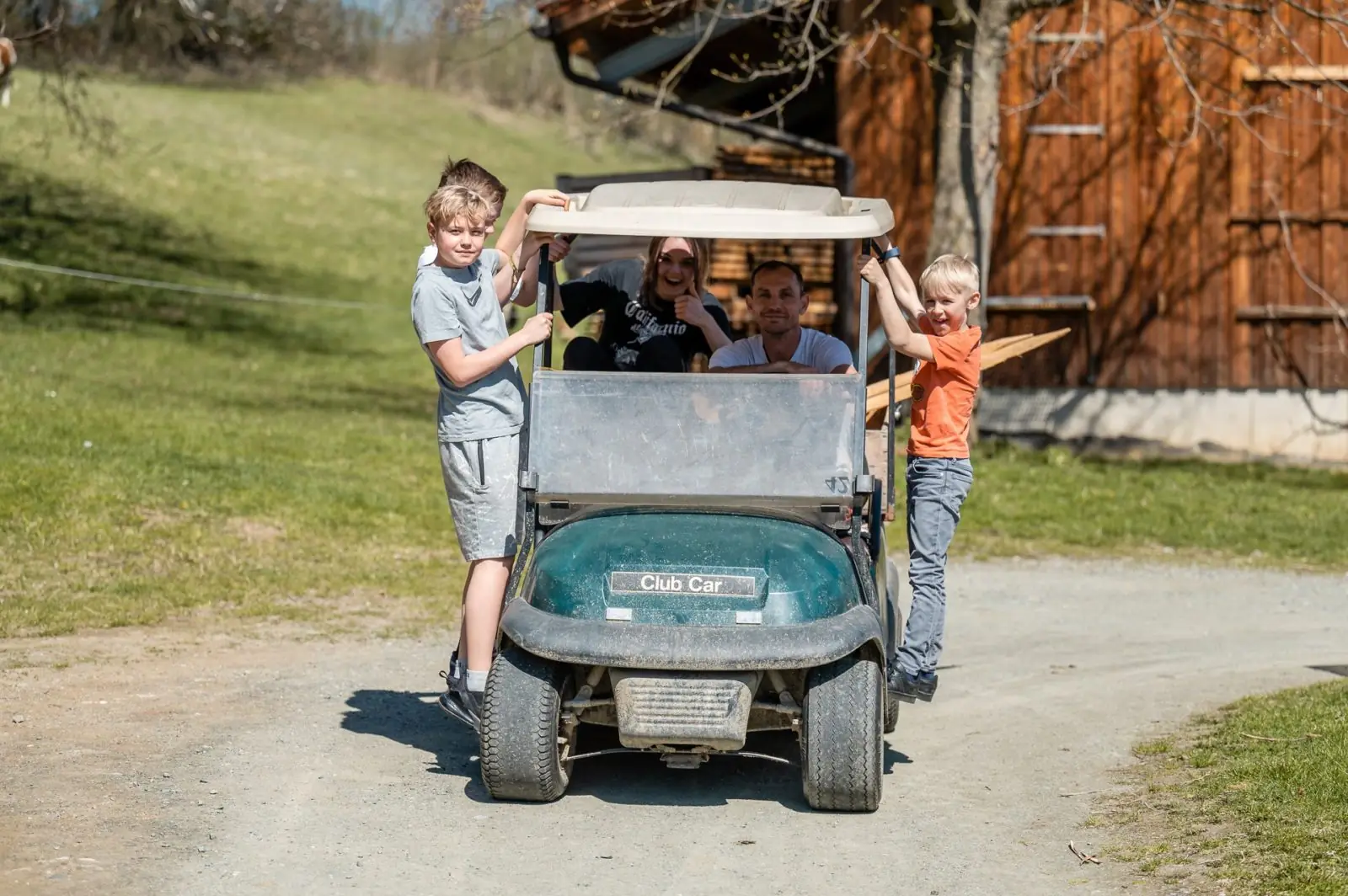 Children driving the electric cart across the farm