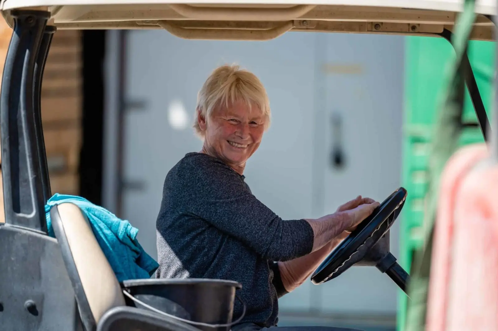 Team member at the wheel of a farm vehicle