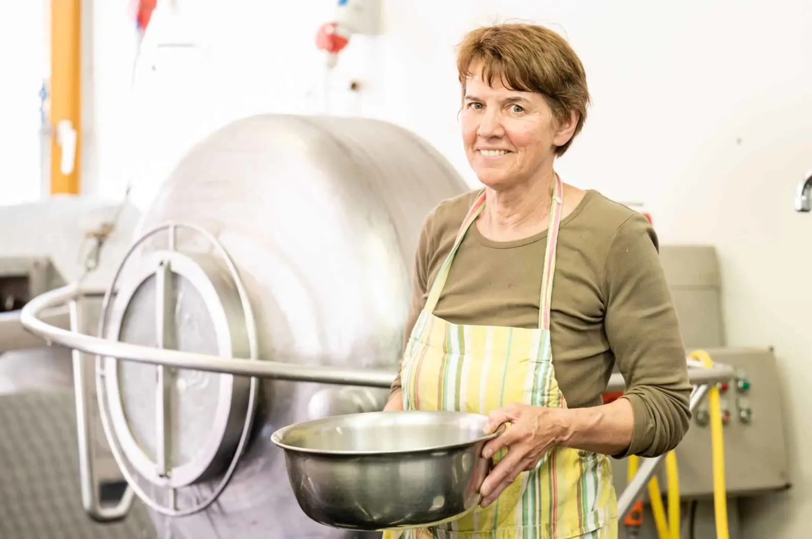Team member at the butter churn in the dairy